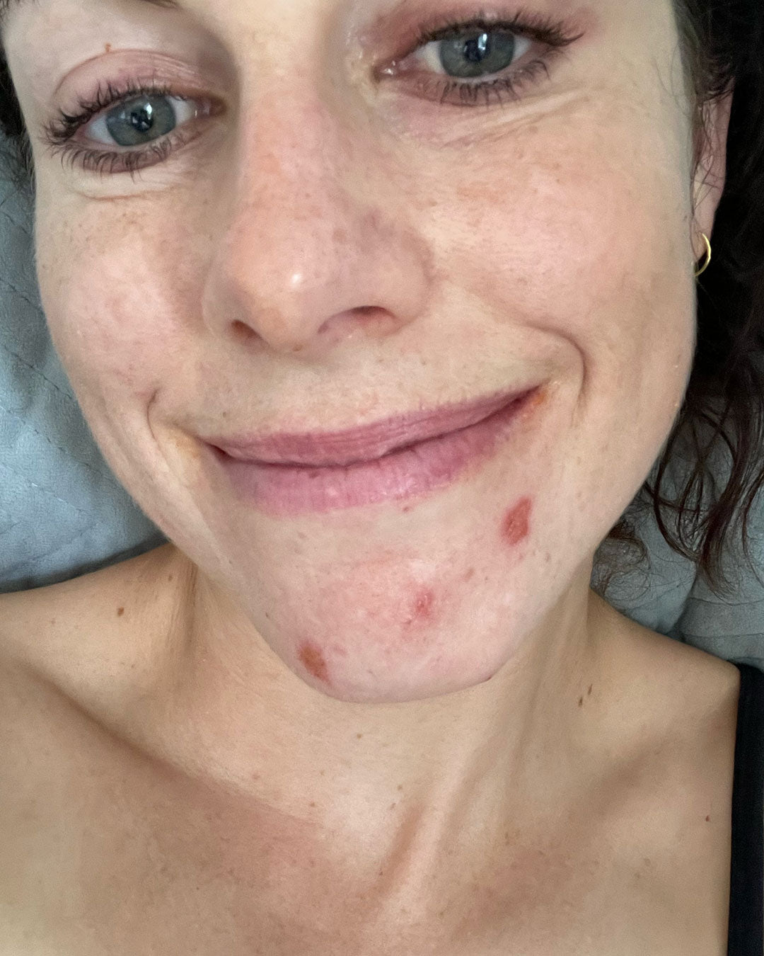 Woman smiling with minimal makeup in natural light