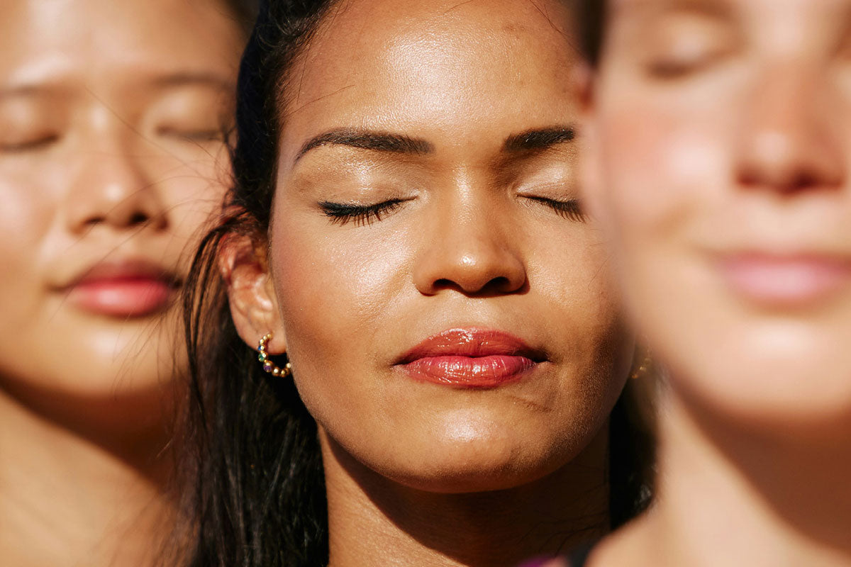 Three women with natural glowing skin in soft daylight