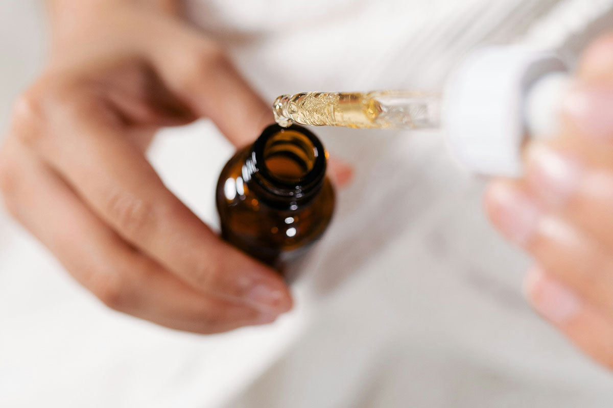 Hands applying skincare product in a minimal setting